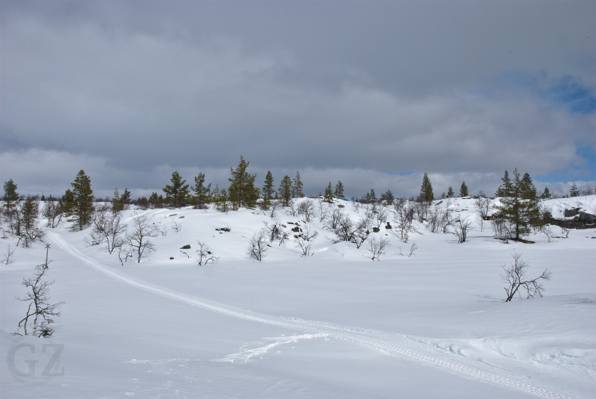 Hannukuru snow mobile tracks in a cliffy valley