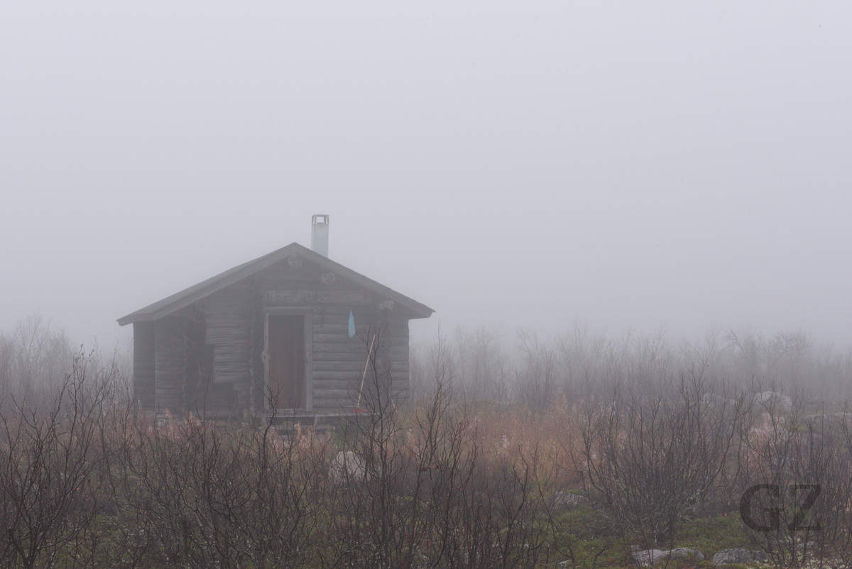 wood cottage in fog